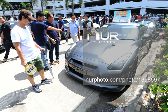 People attend an auction of seized luxury cars at the Thai Customs headquarters in Bangkok Aug. 23, 2016. A total of 343 seized luxury cars...