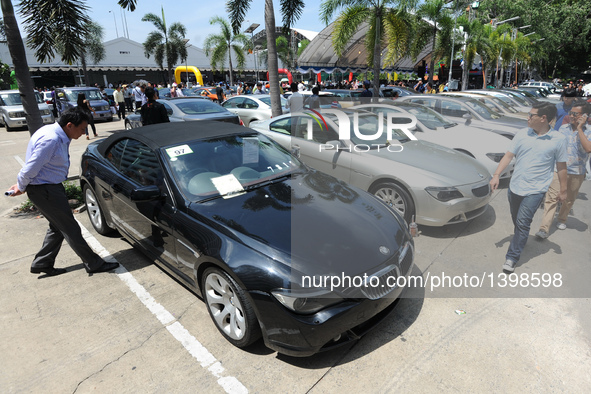 People attend an auction of seized luxury cars at the Thai Customs headquarters in Bangkok Aug. 23, 2016. A total of 343 seized luxury cars...