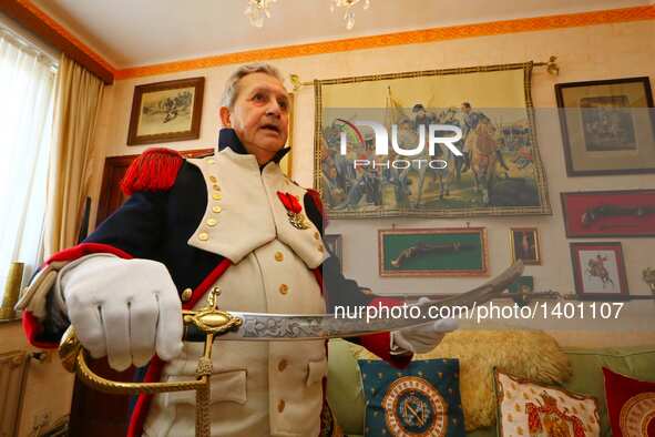 Jasques Fieuw presents a Napoleonic weapon replica as he is dressed in Napoleonic French military uniform at his home in Brussels, Belgium,...