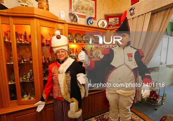 Jasques Fieuw and his wife Pauline react as they are dressed in Napoleonic French military uniforms at their home in Brussels, Belgium, Aug....