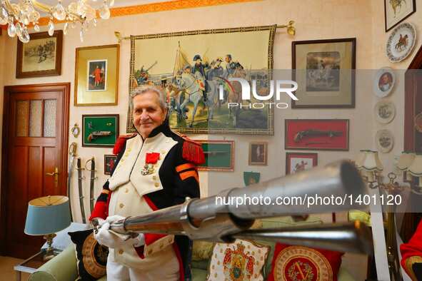 Jasques Fieuw presents a Napoleonic weapon replica as he is dressed in Napoleonic French military uniform at their home in Brussels, Belgium...