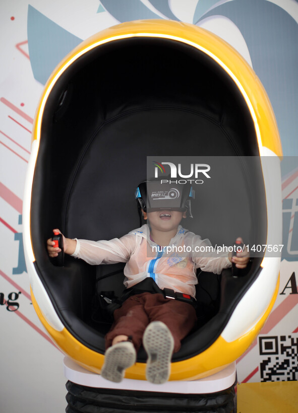 A boy experiences a virtual reality flight simulator during the 5th Shenyang Faku International Flight Conference in Faku County of Shenyang...