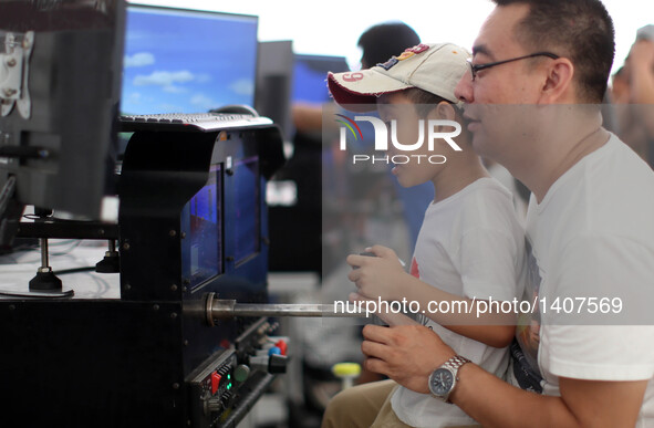 A boy experiences a virtual reality flight simulator during the 5th Shenyang Faku International Flight Conference in Faku County of Shenyang...