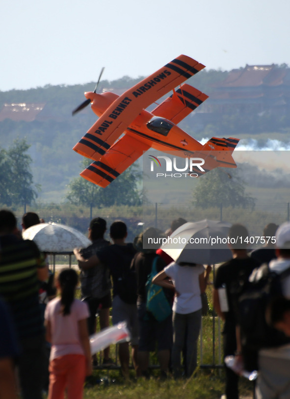 A plane flies during an acrobatic show at the 5th Shenyang Faku International Flight Conference held in Faku County of Shenyang, capital of...