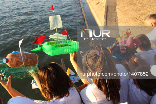 Children put boat models in the Sava River during the 12th Boat carnival in Belgrade, Serbia, on Aug. 27, 2016. About 100 decorated boats of...