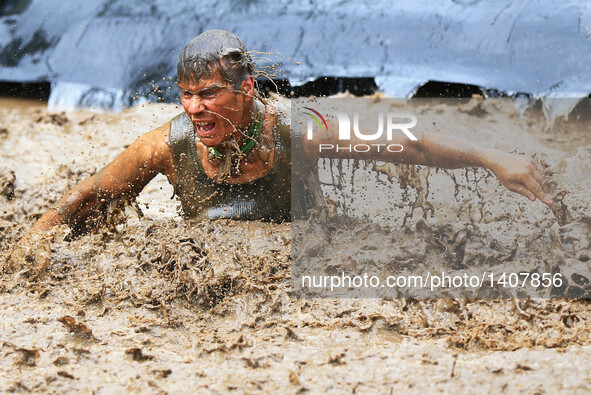 A participant takes part in the "2016 Mud Hero Toronto North" race at Albion Hills Conservation Area in Toronto, Canada, Aug. 27, 2016.