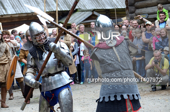 People dressed as European knights fight during "Volga standard", a festival reenacting the Middle Ages and the lifestyle of the Slavic peop...