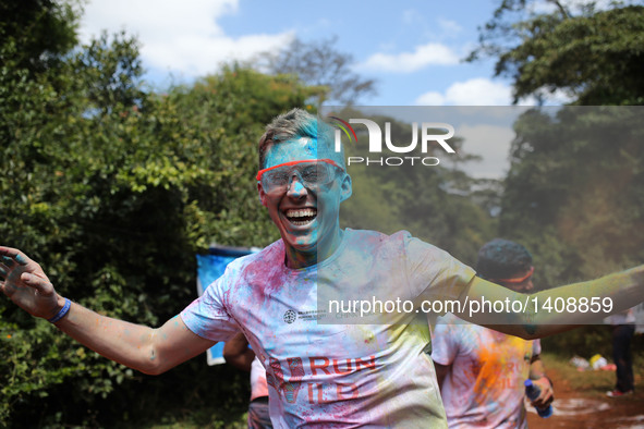 A runner participates in the Color Run in Nairobi, capital of Kenya, Aug. 28, 2016. The Color Run, known as "Happiest 5km on the Planet", wa...