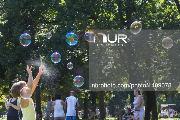 A child plays with soap bubbles on the soap bubble day at a park in Budapest, Hungary, Aug. 28. 2016.