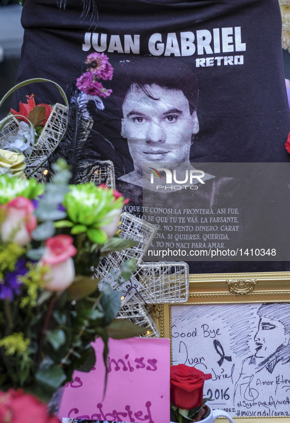 Flowers and candles surround the Hollywood Walk of Fame star of Juan Gabriel in Los Angeles, California, the United States, Aug. 29, 2016. B...