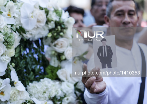 A fan shows a picture of Juan Gabriel at the Hollywood Walk of Fame star of Gabriel in Los Angeles, California, the United States, Aug. 29,...