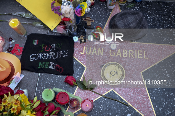 Flowers and candles surround the Hollywood Walk of Fame star of Juan Gabriel in Los Angeles, California, the United States, Aug. 29, 2016. B...