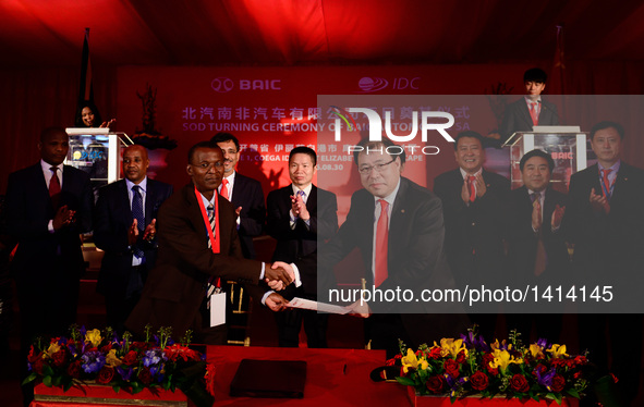 Dong Haiyang (R F), chairman of Beijing Automotive Industry Group (BAIC) Automobile SA, shakes hands with Pepi Silinga, chief executive offi...