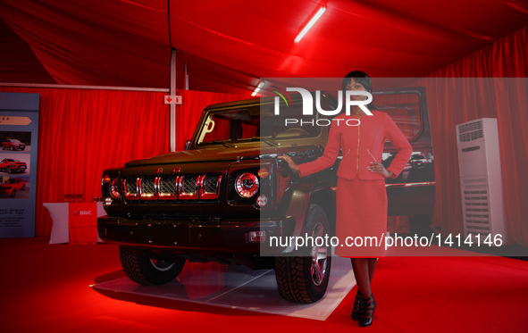 A model shows a BJ80 vehicle produced by the Beijing Automotive Industry Group (BAIC) before the sod turning ceremony of BAIC Automobile SA,...