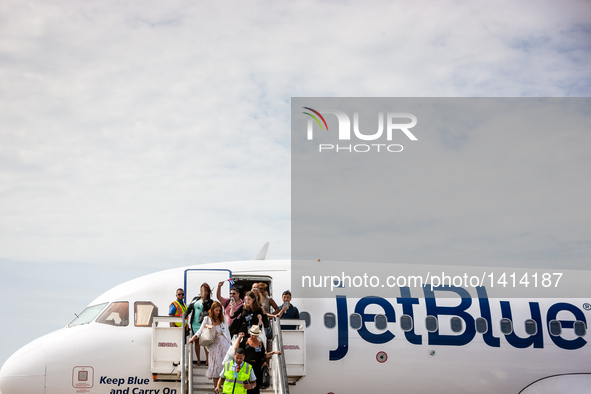 Passengers step down from the first commercial flight from U.S., at the Abel Santamaria International Airport in the central Cuban city of S...