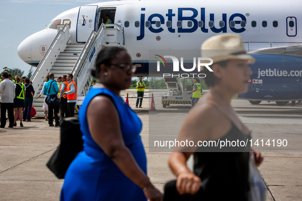 Passengers from the first commercial flight from U.S., arrive at the Abel Santamaria International Airport in the central Cuban city of Sant...