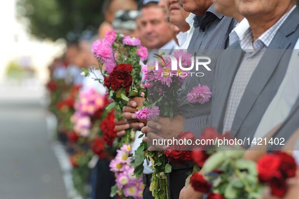 People holding flowers gather along the road to pay tribute to the late president of Uzbekistan Islam Karimov in Samarkand, Uzbekistan, on S...