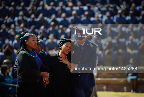 A relative of deceased police officer (2nd R) weeps during the commemoration for 40 deceased police officers in Pretoria, South Africa, Sept...