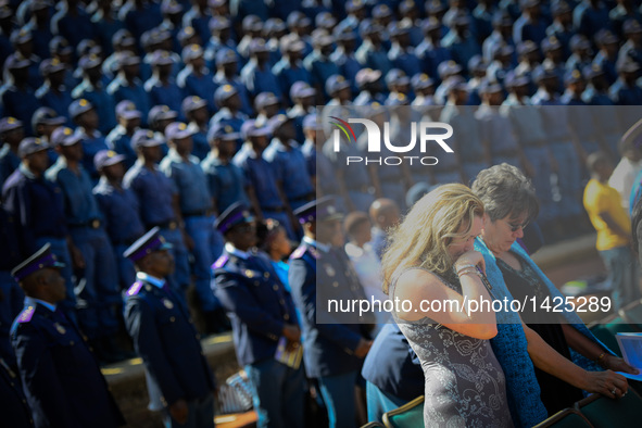 Two women weep for their lost family member during the commemoration for 40 deceased police officers in Pretoria, South Africa, Sept. 4, 201...