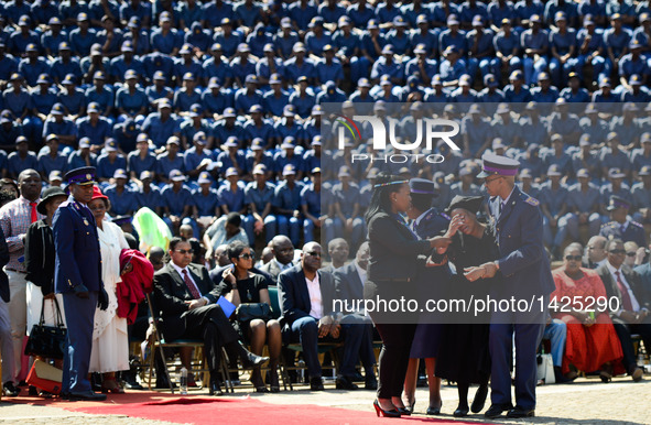 A relative of deceased police officer (2nd R) weeps during the commemoration for 40 deceased police officers in Pretoria, South Africa, Sept...