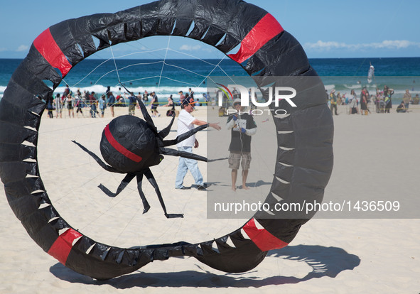 A participant prepares to fly a spider-shaped kite at Bondi Beach in Sydney, Australia, Sept. 11, 2016. Australia's largest kite flying fest...