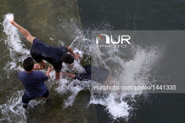 Egyptian boys swim in the River Nile at the Qanater Bridge during the Eid al-Adha festival in Qaliubiya, Egypt on Sept. 14, 2016.