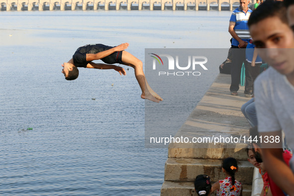 An Egyptian boy jumps into the River Nile at the Qanater Bridge during the Eid al-Adha festival in Qaliubiya, Egypt on Sept. 14, 2016.