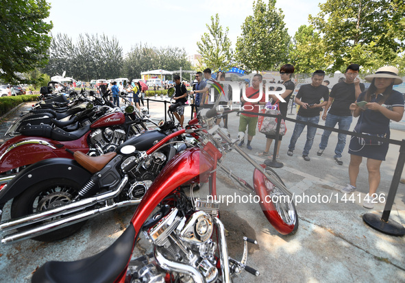 Visitors watch vintage vehicles during a vintage vehicle fair in Beijing, capital of China, Sept. 15, 2016. More than 100 vintage vehicles w...