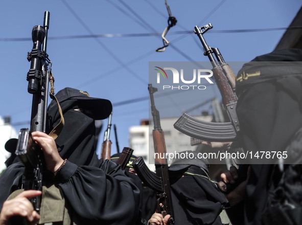 Palestinian women from the Islamic Jihad (Holy War) hold their weapons during a demonstration marking the one year anniversary of latest rou...