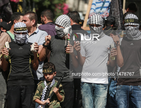 Palestinian militants from the Islamic Jihad (Holy War) take part in a demonstration marking the one year anniversary of latest round of Pal...