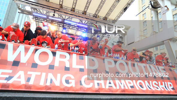 Contestants take part in the 7th Annual World Poutine Eating Championship in Toronto, Canada, Oct. 1, 2016. Joey Chestnut of the United Stat...