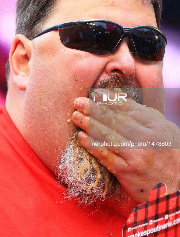 A contestant takes part in the 7th Annual World Poutine Eating Championship in Toronto, Canada, Oct. 1, 2016. Joey Chestnut of the United St...