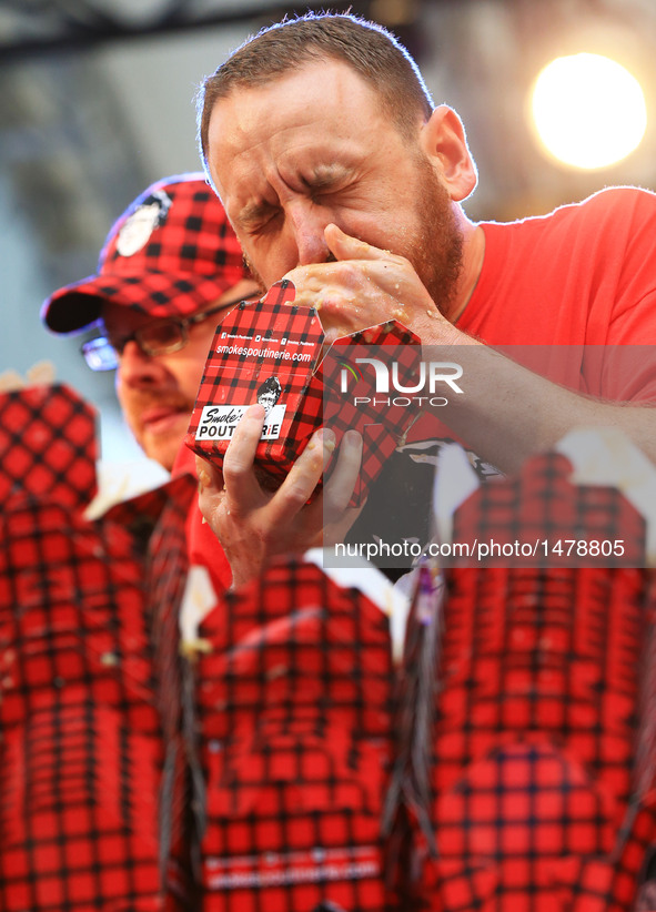 Joey Chestnut (R) of the United States takes part in the 7th Annual World Poutine Eating Championship in Toronto, Canada, Oct. 1, 2016. Joey...