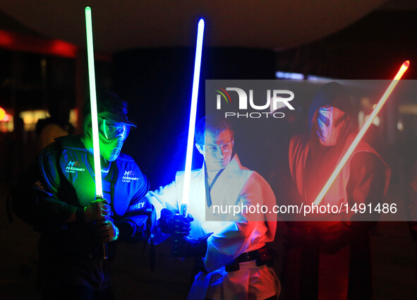 Dressed-up participants pose for photos during the 2016 Glow Sword Battle in Toronto, Canada, Oct. 8, 2016. Hundreds of Star Wars fans took...