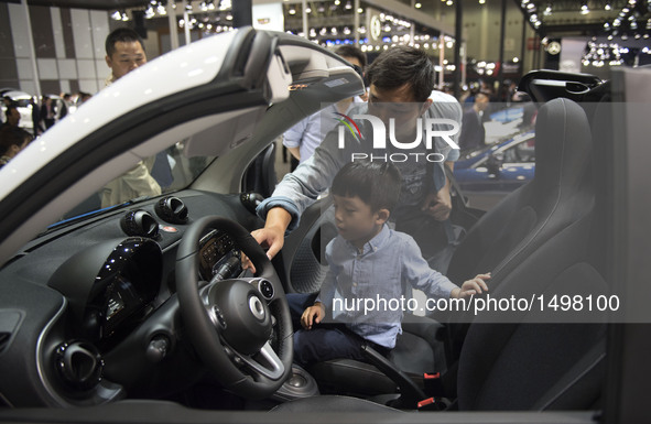 People visit the Wuhan Motor Show 2016 in Wuhan, capital of central China's Hubei Province, Oct. 12, 2016. Over 300 exhibitors from more tha...