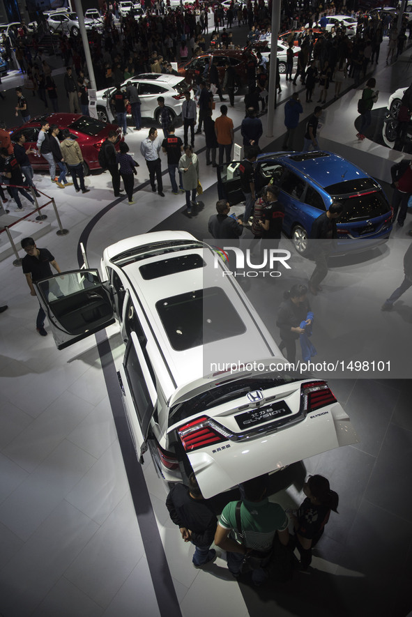 People visit the Wuhan Motor Show 2016 in Wuhan, capital of central China's Hubei Province, Oct. 12, 2016. Over 300 exhibitors from more tha...