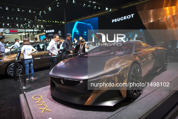 People view a concept car of Peugeot at Wuhan Motor Show 2016 in Wuhan, capital of central China's Hubei Province, Oct. 12, 2016. Over 300 e...