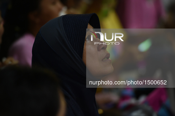 A woman mourns for the death of Thai King Bhumibol Adulyadej outside Siriraj Hospital in Bangkok, capital of Thailand, on Oct. 13, 2016. Tha...