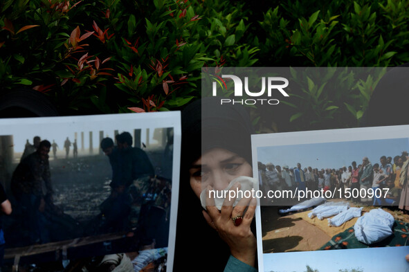 A woman holds posters during a rally protesting airstrikes at a funeral hall in Yemen, in front of Saudi Arabian embassy in Jakarta, Indones...