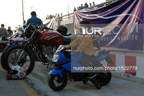 A boy sits on a motorbike during a car show in Islamabad, capital of Pakistan on Oct. 23, 2016. The Islamabad Auto Show 2016, orchestrated b...