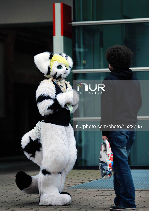 A cosplayer (L) visits the Frankfurt Book Fair in Frankfurt, Germany, on Oct. 23, 2016. The finale of the 10th German Cosplay Championship c...