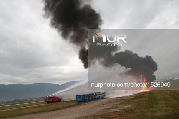 A fire truck extinguishes a fire during an emergency rescue drill at Sarajevo International Airport, Bosnia and Herzegovina, on Oct. 26, 201...