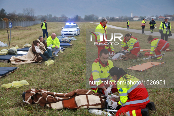 Medical workers take care of "wounded people" during an emergency rescue drill at Sarajevo International Airport, Bosnia and Herzegovina, on...