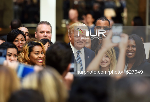 U.S. Republican presidential nominee Donald Trump poses for photos during the opening and ribbon cutting ceremony of Trump International Hot...