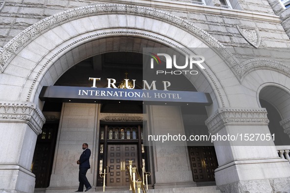 A staff member stands in front of the Trump International Hotel in Washington, D.C., the United States on Oct. 26, 2016. The opening and rib...