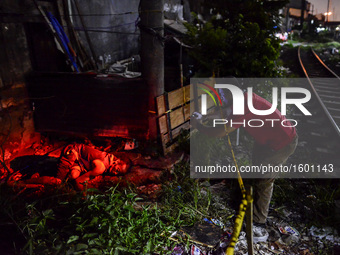 (EDITORS NOTE: Image depicts graphic content.) A member of the police's homicide division takes pictures of the corpse of a suspected drug p...