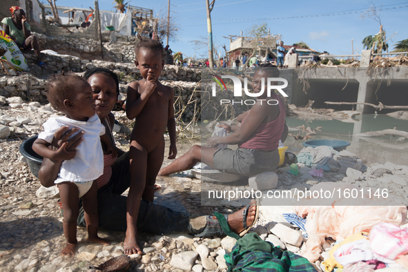 Women and children wash in the river after hurricane Matthew destroyed and flooded their houses, on October 7, 2016. Hurricane Matthew kille...