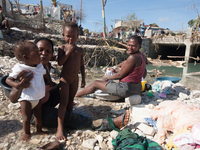 Women and children wash in the river after hurricane Matthew destroyed and flooded their houses, on October 7, 2016. Hurricane Matthew kille...