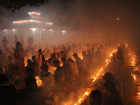 Bangladeshi Hindu devotees sit with candle light pray to God at Shri Shri Lokanath Brahmachari Ashram temple during the religious festival K...