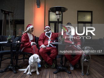 Runners dressed as Santa Claus take part in the 3rd edition of the 'Athens Santa Claus Run' in central Athens, on December 4, 2016. (